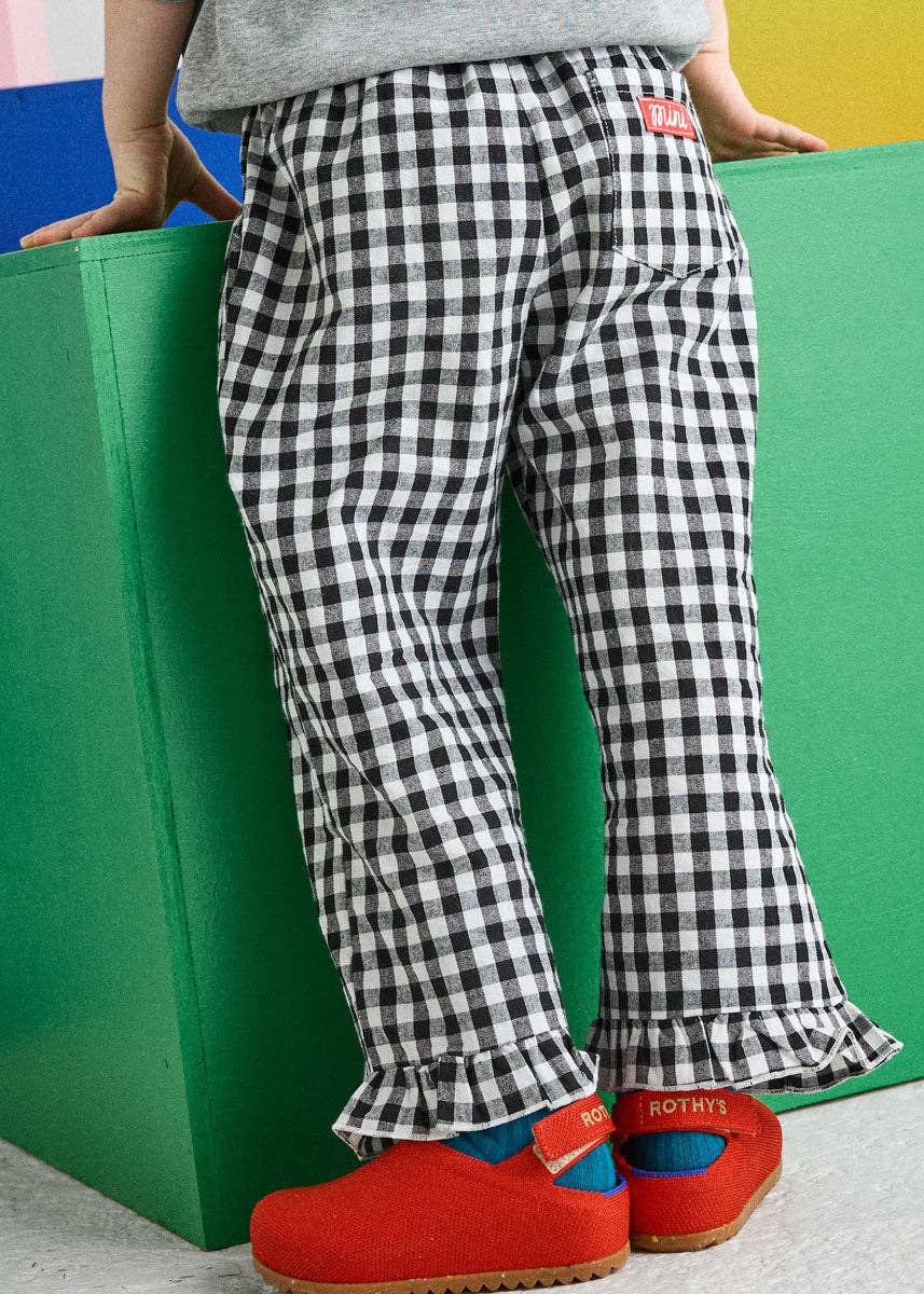Black and white gingham kids pants with hip pockets and elastic waistband