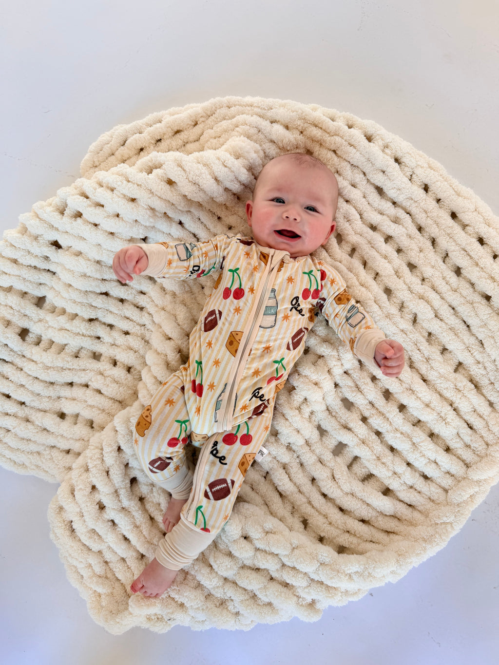 Baby zip sleeper in buttery-soft fabric with playful Wisconsin icons