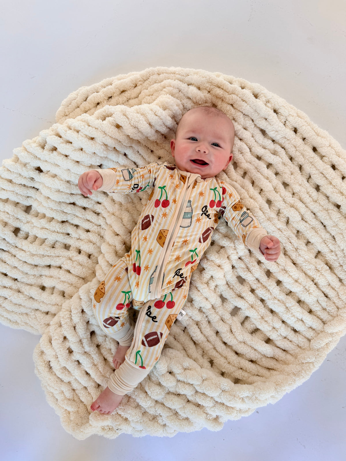 Baby zip sleeper in buttery-soft fabric with playful Wisconsin icons