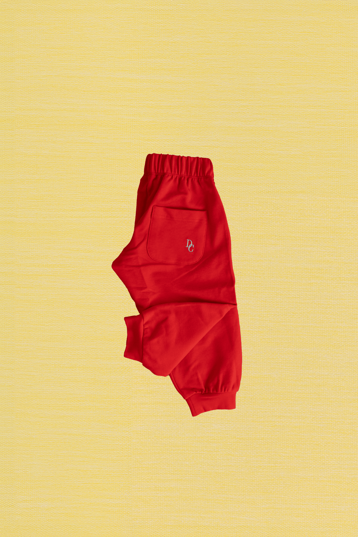 Cherry red kids joggers with embroidered detail on the back pocket