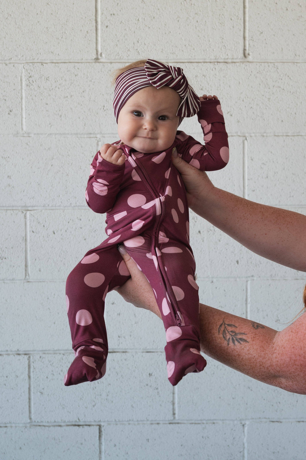Pink dot zip pajamas with rollover hand cuffs on smaller sizes