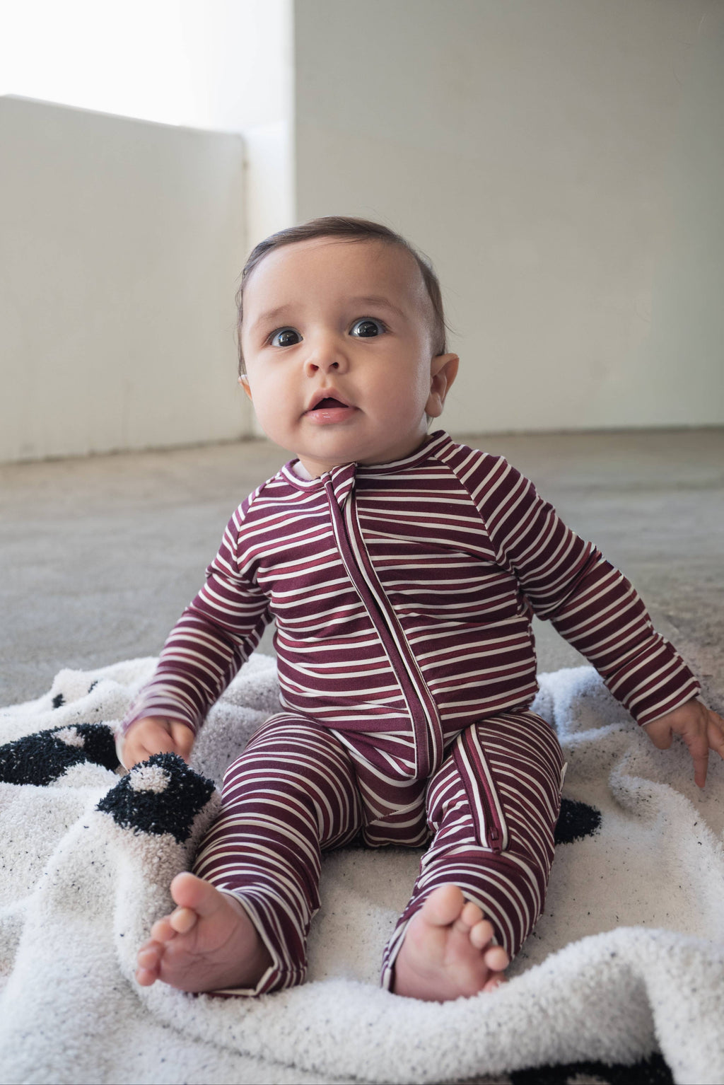 Maroon striped baby zip pajamas in stretchy bamboo viscose