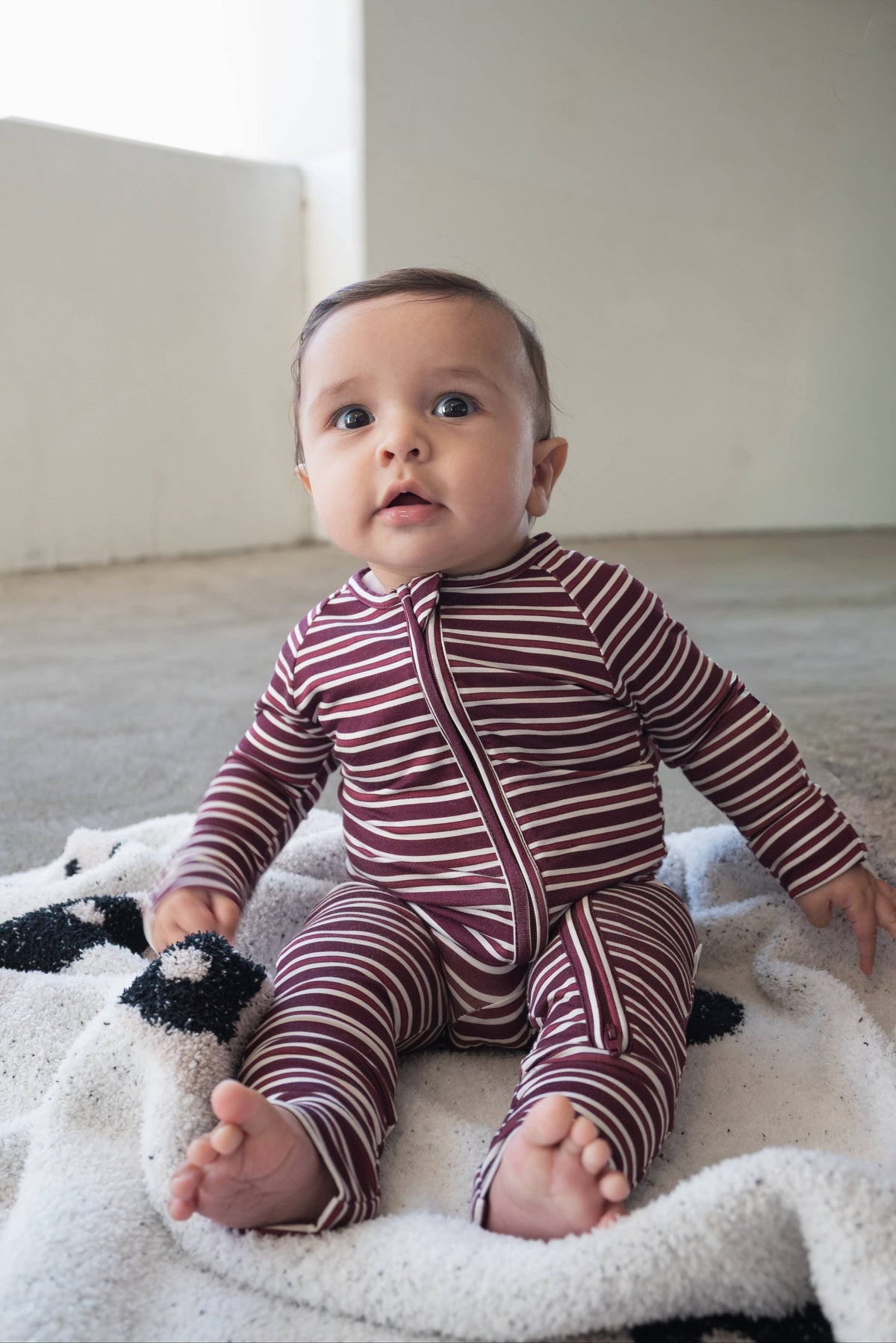 Maroon striped baby zip pajamas in stretchy bamboo viscose