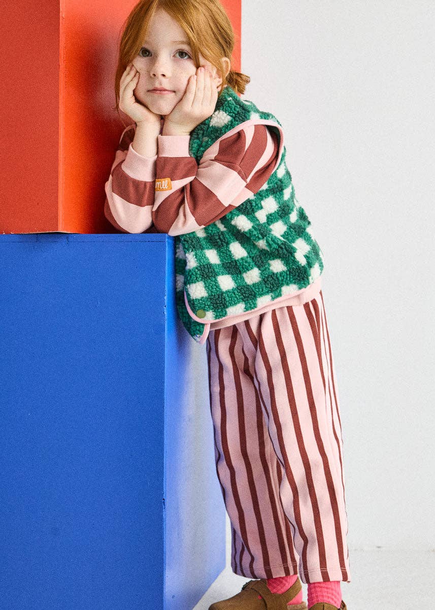 Back pocket with colorful logo on the pink and burgundy striped pants