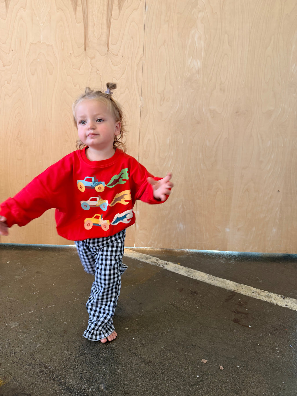 Cherry red kids sweatshirt with three vintage-inspired monster trucks across the front